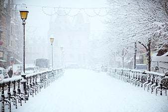 Snowy City Street with Vintage Lamp Posts and Railing