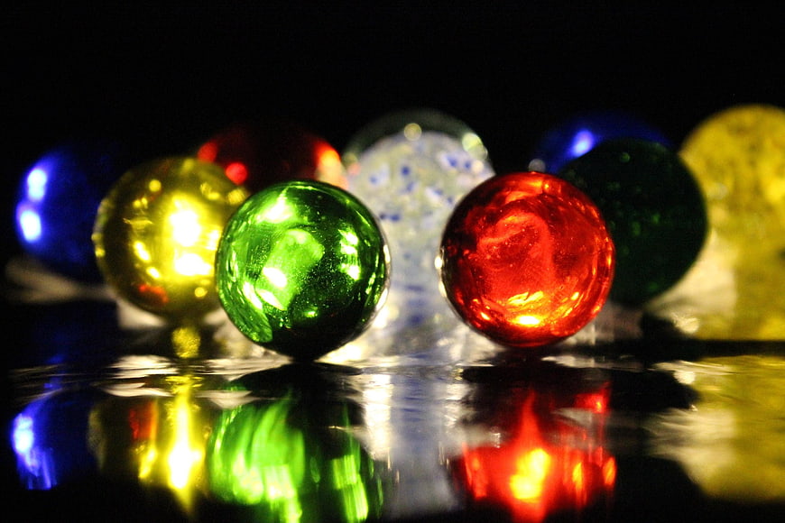 Colorful glass marbles with reflections on dark background