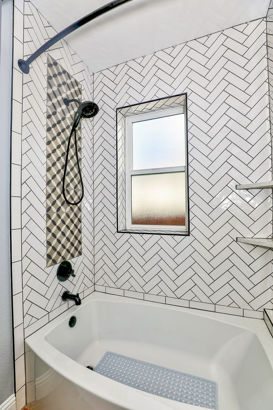 Modern Bathroom with Herringbone Tiles and Black Fixtures