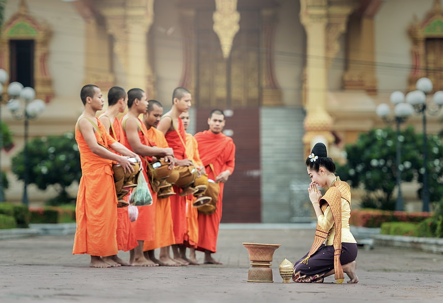 Buddhist Monks Receiving Alms from Woman in Traditional Dress