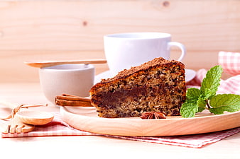 Slice of Cinnamon Cake with Coffee on Wooden Table