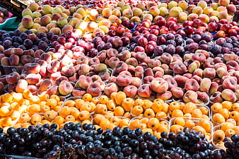 Colorful assortment of fresh summer fruits at a market