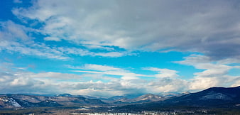Panoramic Winter Mountain Landscape with Blue Sky and Clouds