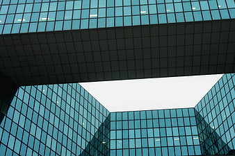 Low angle view of modern blue glass office building architecture