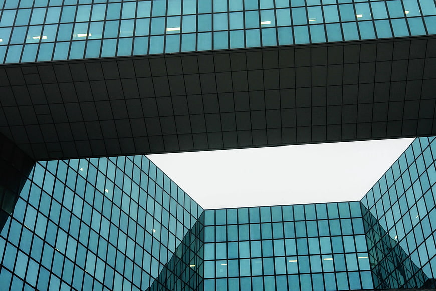 Low angle view of modern blue glass office building architecture