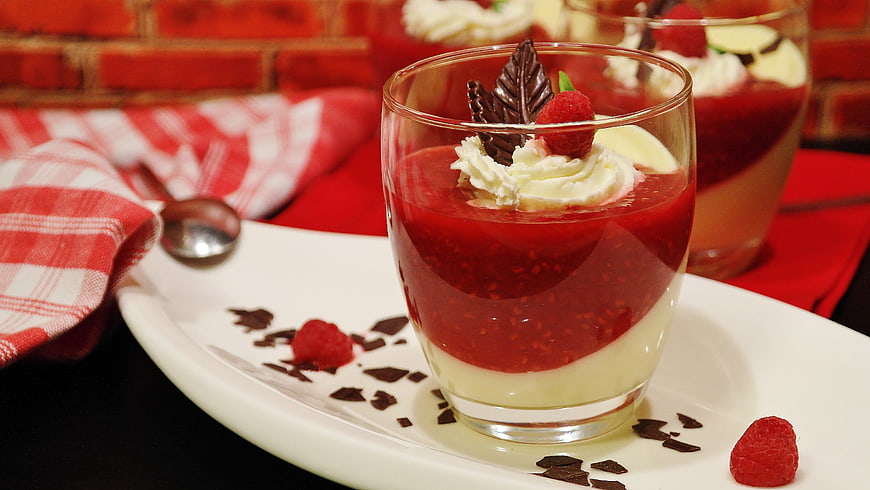 Raspberry and Vanilla Pudding Dessert in Glass with Chocolate Garnish