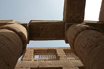 Low angle view of ancient Egyptian temple columns with hieroglyphics