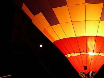 Illuminated Hot Air Balloon at Night with Moon