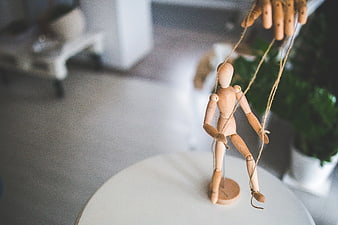 Wooden marionette puppet controlled by hand strings