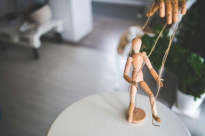 Wooden marionette puppet controlled by hand strings