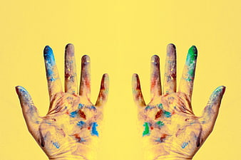 Colorful Painted Hands on Yellow Background