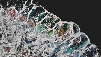 Aerial View of Turquoise Ocean Waves Crashing on Dark Reef