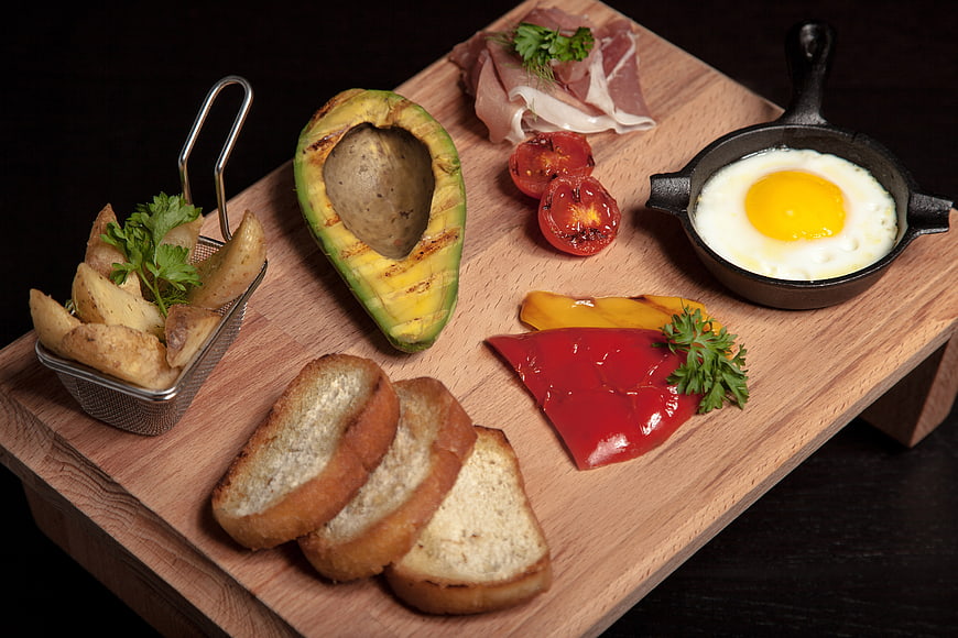 Gourmet breakfast platter with egg, avocado, and toast