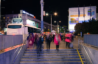 Night Cityscape of Warsaw with Blurred Pedestrians and Bus