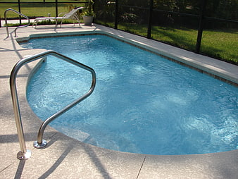 Outdoor Swimming Pool with Metal Handrail and Lounge Chair