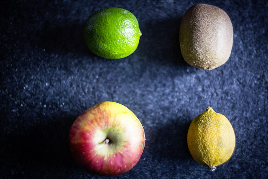 Top view of fresh fruits on dark textured background