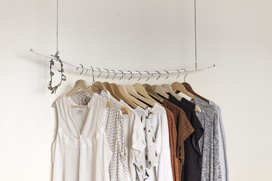 Minimalist Clothing Rack with Neutral Tones and Wooden Hangers