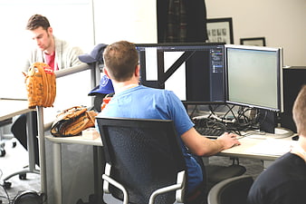 Graphic Designer Working at Dual Monitors in Modern Office