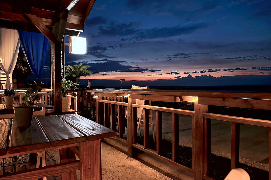 Cozy Wooden Beach House Deck At Dusk With Ocean Sunset View