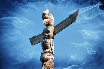 Indigenous Totem Pole with Ethereal Blue Smoke Background