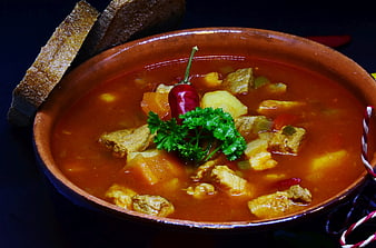 Traditional Hungarian Goulash Soup In Terracotta Bowl With Bread