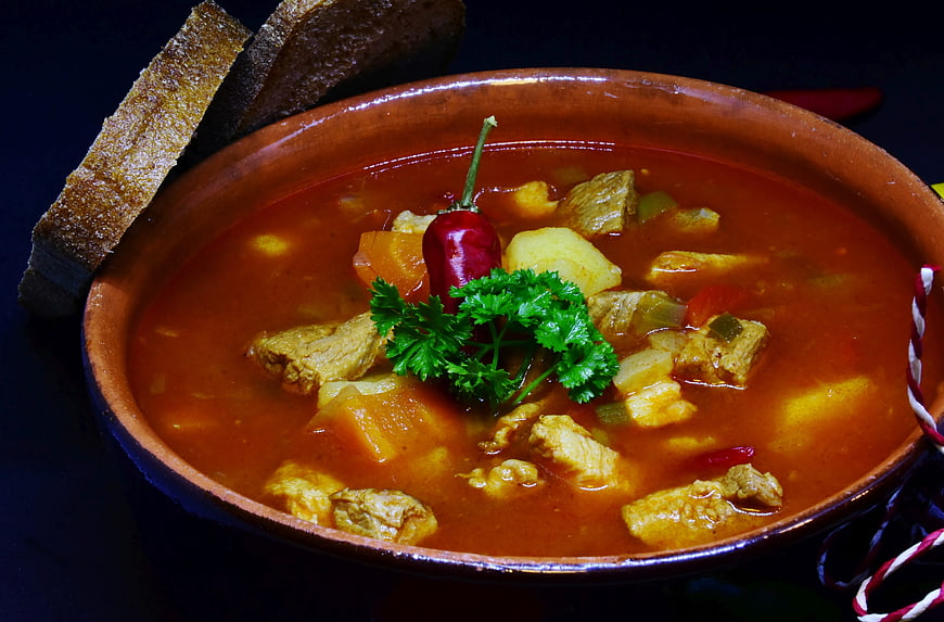 Traditional Hungarian Goulash Soup In Terracotta Bowl With Bread