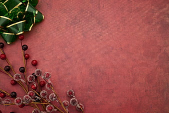 Christmas Gift Bow and Frosted Berries on Red Background