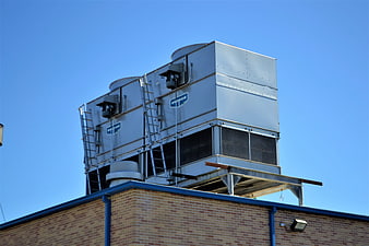 Industrial HVAC Cooling Tower on Brick Building Roof