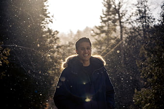 Happy Man Smiling in Snowy Winter Forest
