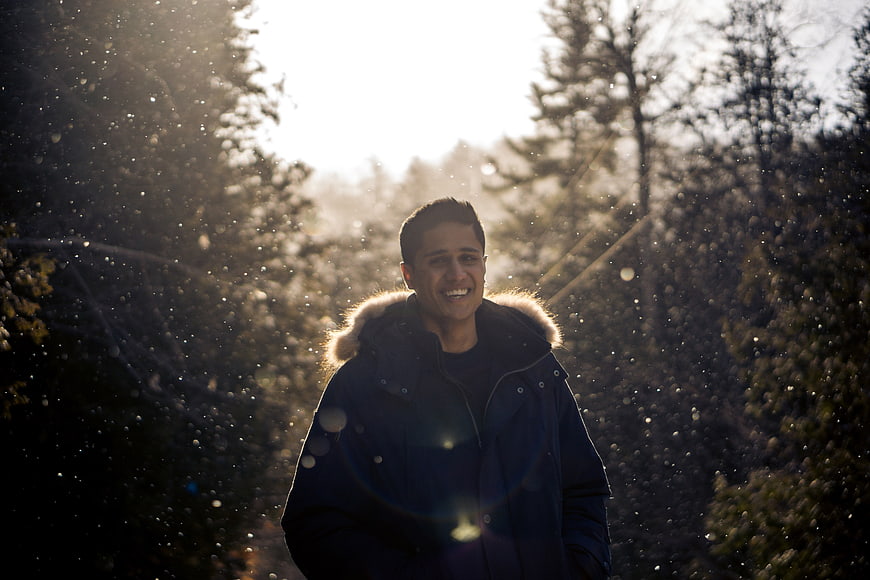 Happy Man Smiling in Snowy Winter Forest