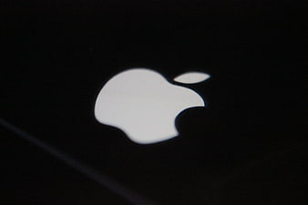 Illuminated Apple Logo On Black Smartphone Surface