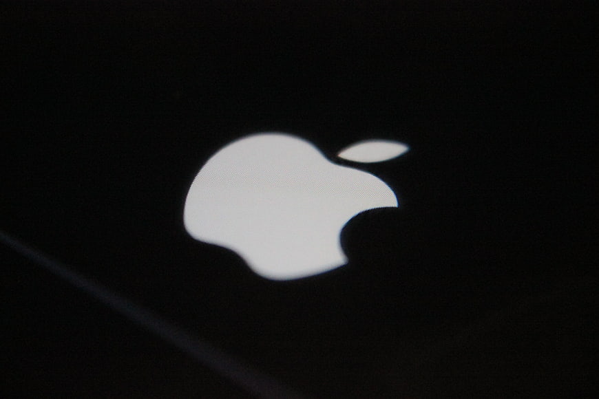 Illuminated Apple Logo On Black Smartphone Surface