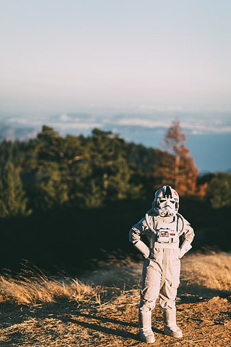 Child in Stormtrooper Costume Standing on Mountain Ridge