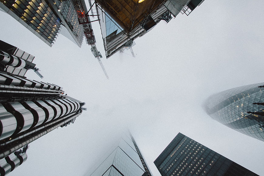 Worm's eye view of skyscrapers in foggy city