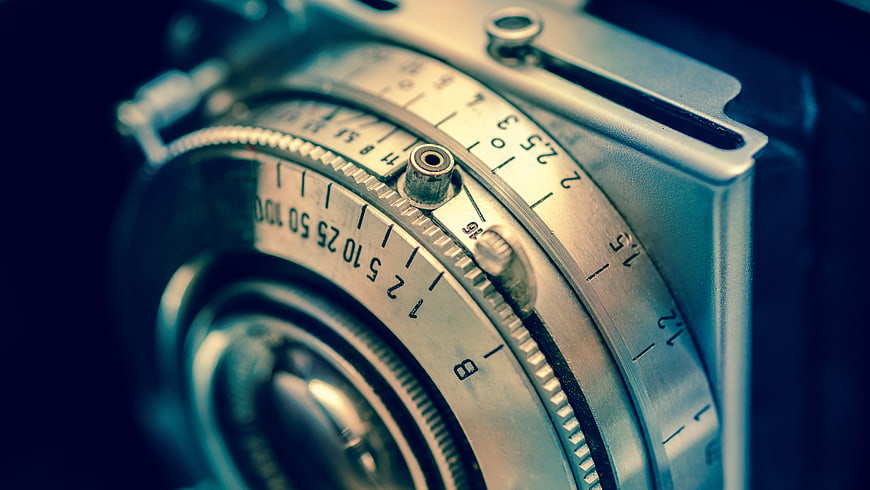 Close-up of Vintage Silver Film Camera Lens and Dials