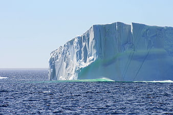 Massive Tabular Iceberg Floating in Deep Blue Ocean