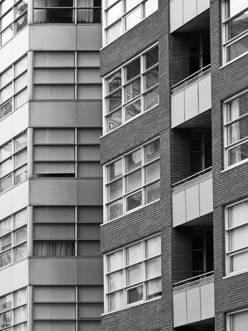 Black and white modern apartment building facade with balconies