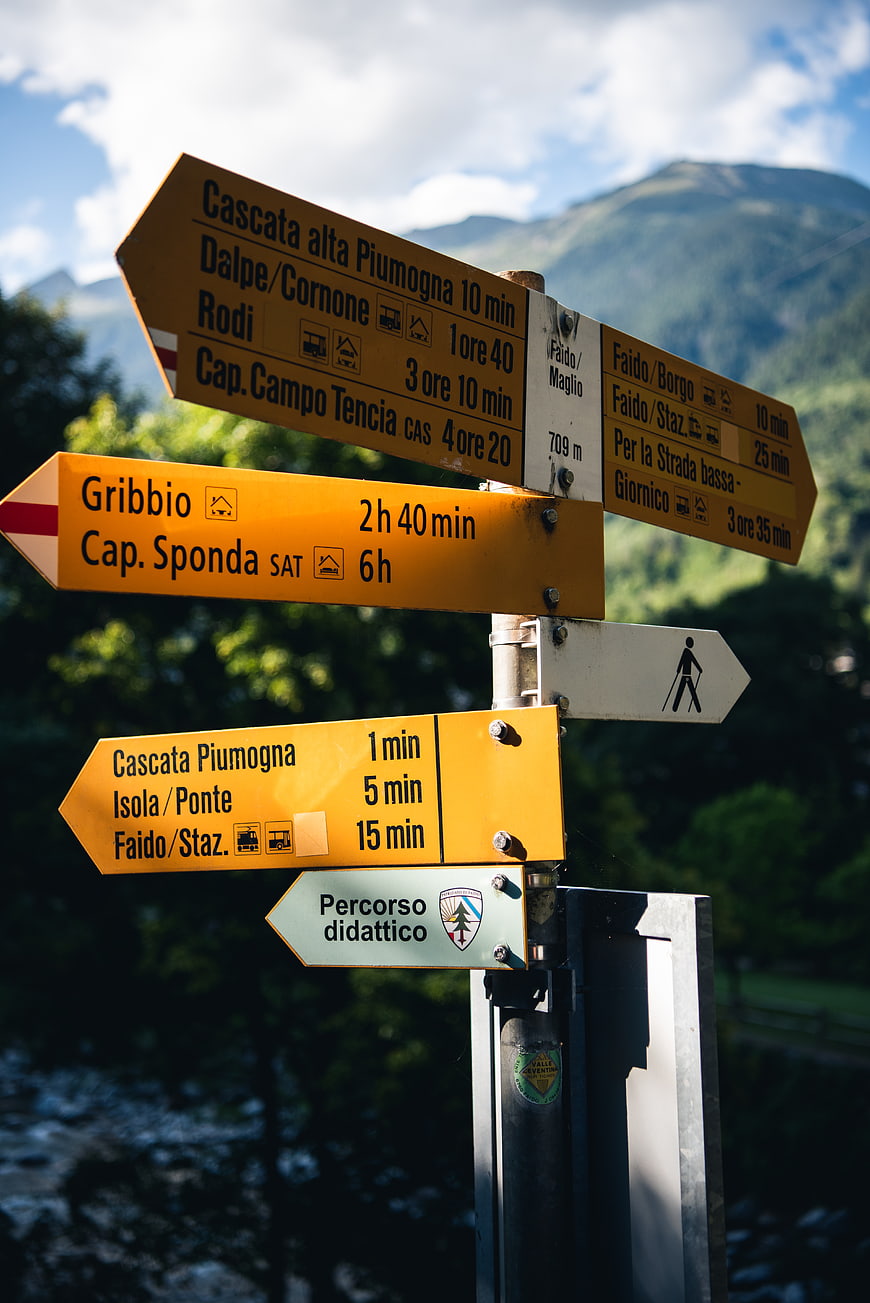 Yellow Hiking Trail Signpost in Mountain Valley