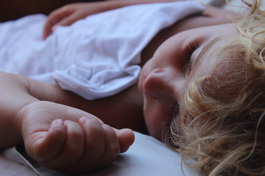 Sleeping Baby With Curly Blonde Hair And Small Hand