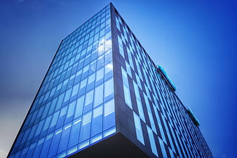 Modern Glass Skyscraper Against Blue Sky