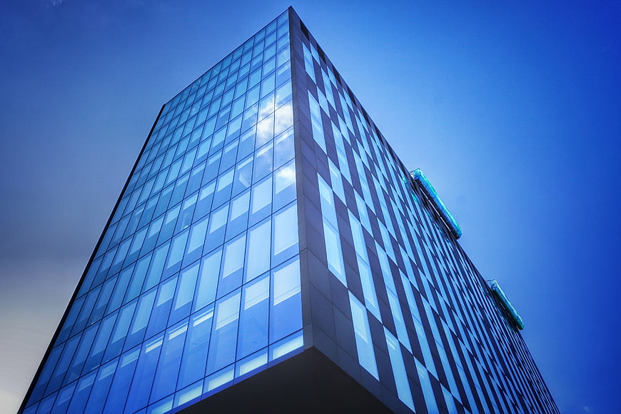 Modern Glass Skyscraper Against Blue Sky