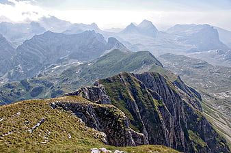 Panoramic Alpine Mountain Ridge with Green Grass and Distant Peaks