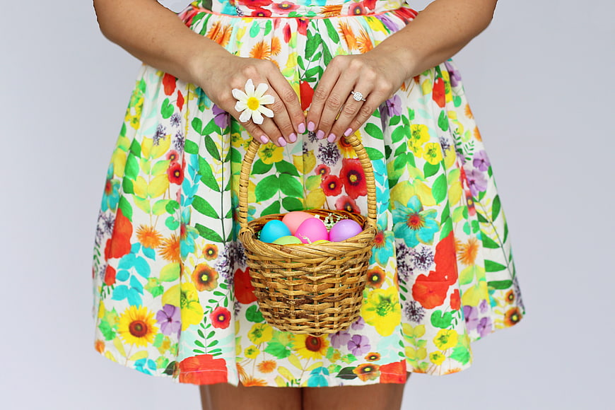 Woman holding Easter basket with colorful eggs