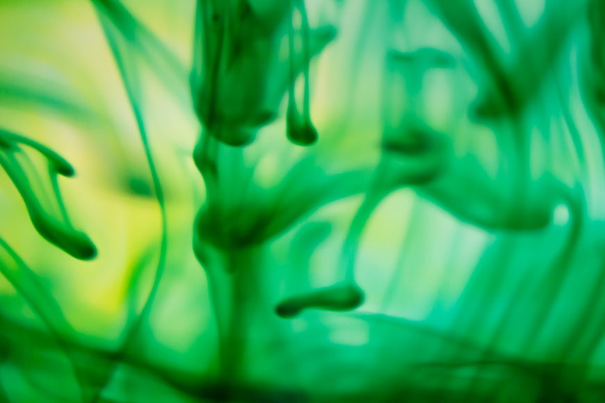 Abstract Green Ink Swirling in Water