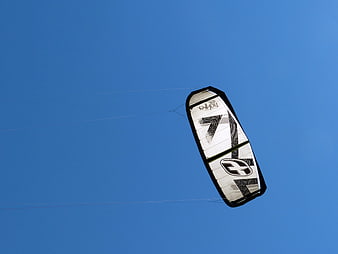 White and Black Kitesurfing Kite Against Blue Sky