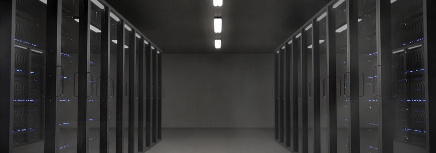 Dark server room with rows of racks and blue LED lights