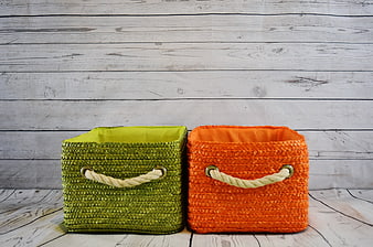Green and Orange Woven Storage Baskets on White Wood