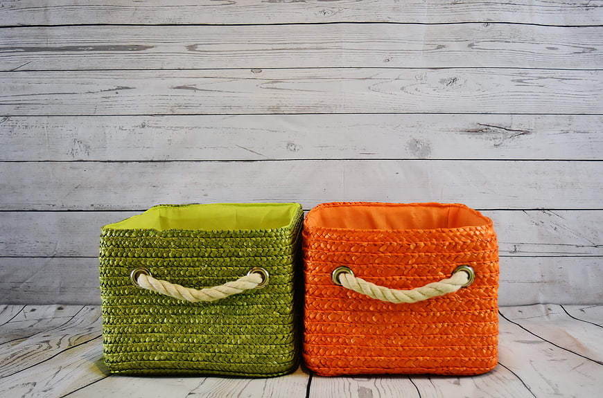 Green and Orange Woven Storage Baskets on White Wood