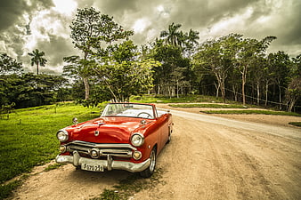 Red Vintage Convertible Classic Car on Dirt Road
