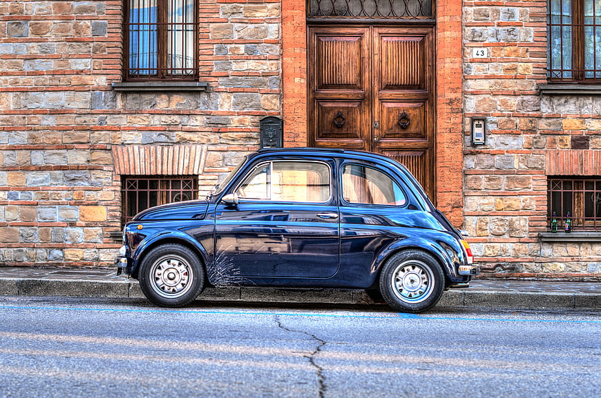 Classic Blue Fiat 500 Parked on Cobblestone Street